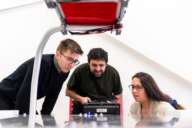 Pessoas operando uma máquina através de uma tela de operação